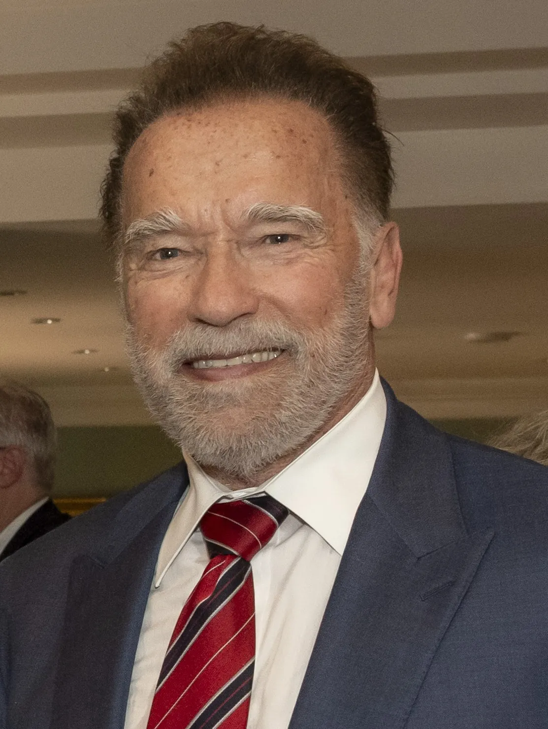 Schwarzenegger in 2025, age 77, still publicly active and still writing. The compounding didn't stop just because the formal job titles did. (Photo: CC-licensed, via Wikimedia Commons)